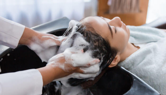 Hair washing process illustrating potential scalp concerns related to Native Shampoo Lawsuit, highlighting hair care safety issues.