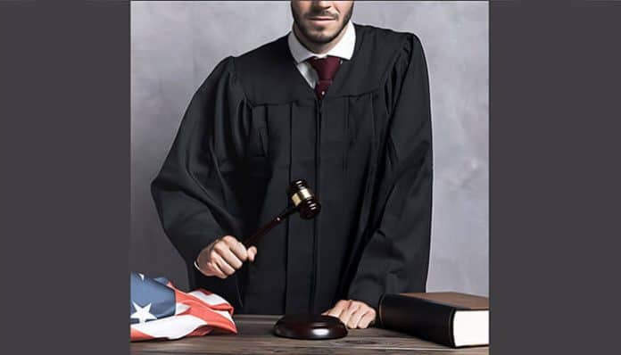 Judge in black robe holding a gavel beside a legal book and American flag, symbolizing justice in a Wrongful Death Claim case.