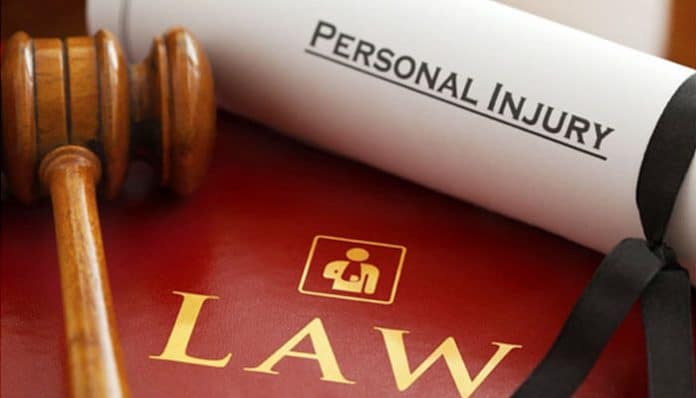 Personal injury law concept with gavel, legal book, and rolled document highlighting personal injury claims and legal representation.