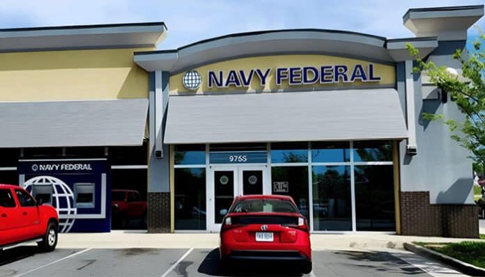 Front view of a Navy Federal Credit Union branch with parked cars, related to the ongoing Navy Federal lawsuit and customer settlement claims.