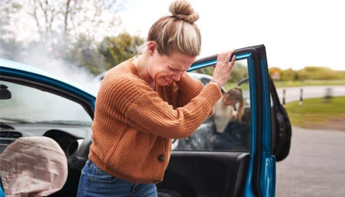 Injured woman holding her head after a crash, highlighting the need for an attorney for car accident to seek legal help and fair compensation.