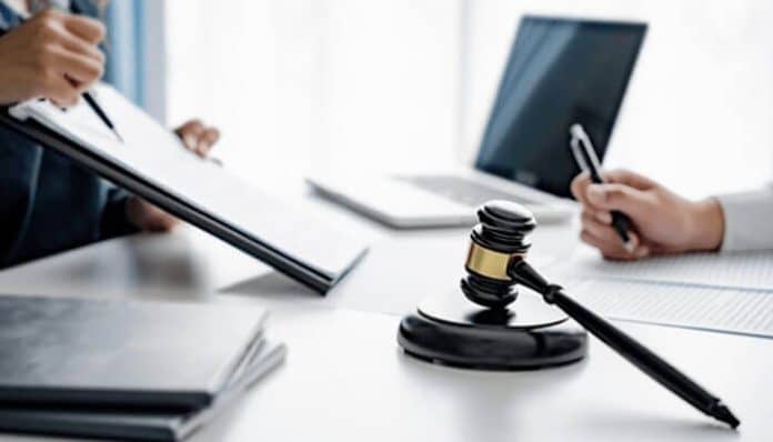 Legal consultation with documents and gavel on desk representing justice and interpretation of the Romeo and Juliet Law.