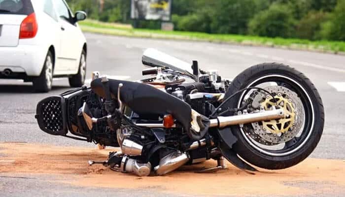Brooklyn's Motorcycle Accident scene showing a crashed bike lying on the road after a collision with a car.