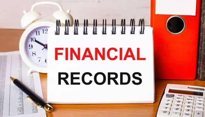 Financial records, calculator, and documents on a desk, representing evidence and compensation details in a Wrongful Death Claim case.