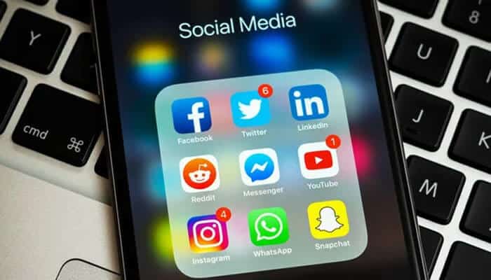 Smartphone screen displaying social media apps like Facebook, Twitter, and LinkedIn, showing how Dropped Criminal Charges continue trending online.