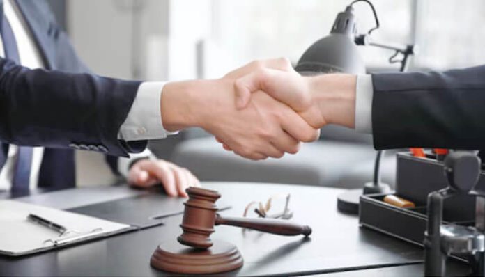 Lawyer and client shaking hands after successfully resolving a Social Security Denial case, symbolizing legal support and justice in disability claims.