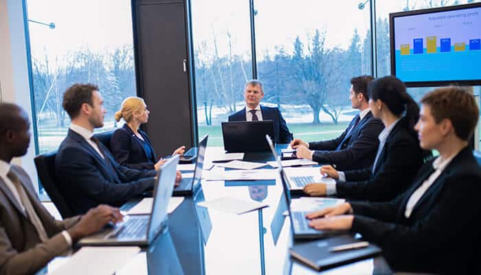 Corporate governance meeting with board members discussing strategy and business performance.