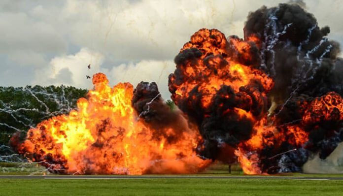 Explosion on a field, illustrating the critical role of regulatory bodies in enforcing safety measures and preventing catastrophic events in high-risk environments