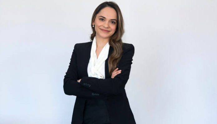 Confident female lawyer in a black suit standing with folded arms, representing a Truck Accident Attorney in Melville ready to help victims seek justice.