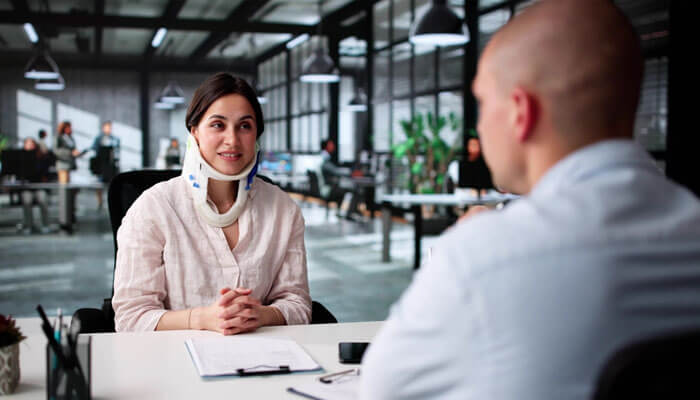 Injured woman consulting Leeson & Leeson personal injury lawyers about her case.