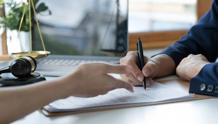 Lawyer discussing legal documents with a client about an 18-wheeler lawsuit case.”