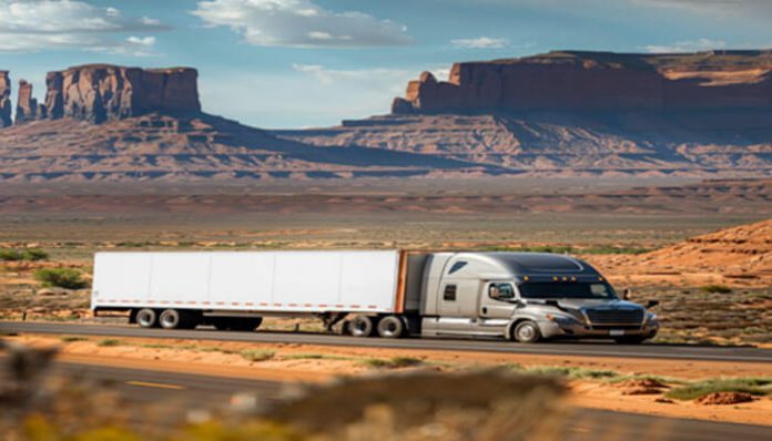 18-wheeler truck driving on a desert highway – image representing an 18-wheeler lawsuit and accident claims timeline.