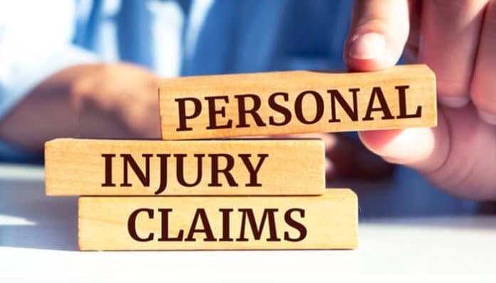 Wooden blocks stacked with the words Personal Injury Claim, symbolizing legal action and compensation process for a Personal Injury Claim.