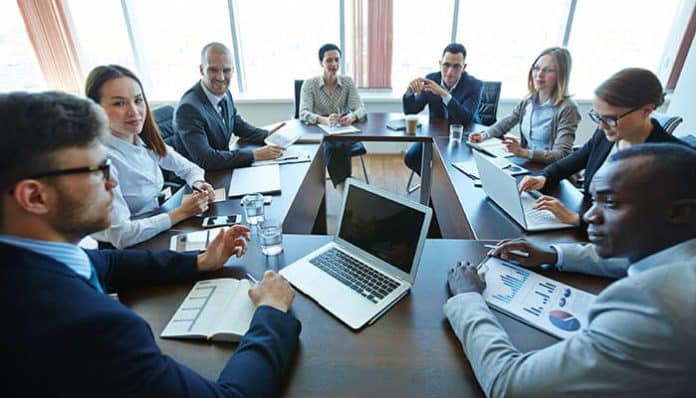 Partnering with a PEO shown through a business team meeting, where leaders discuss employee benefits, compliance, and HR strategies.