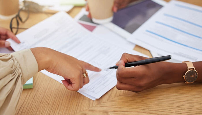 Applicant reviewing and filling out paperwork with legal guidance after a Social Security Denial, preparing documents for reconsideration and appeal.