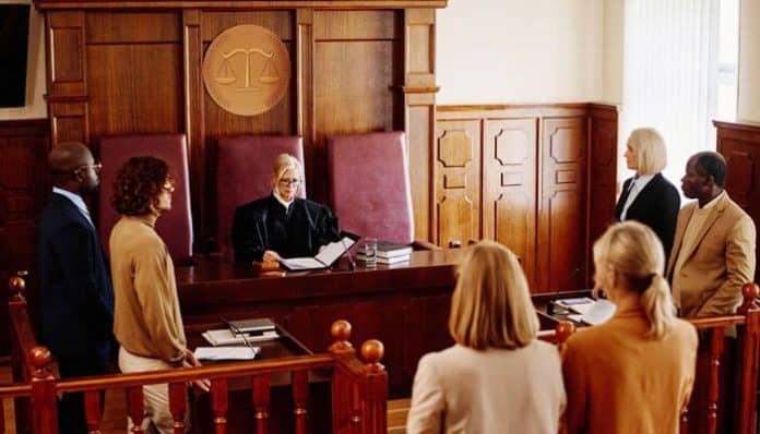 A courtroom scene with a judge and attorneys, illustrating the legal process and explaining What is a status hearing.