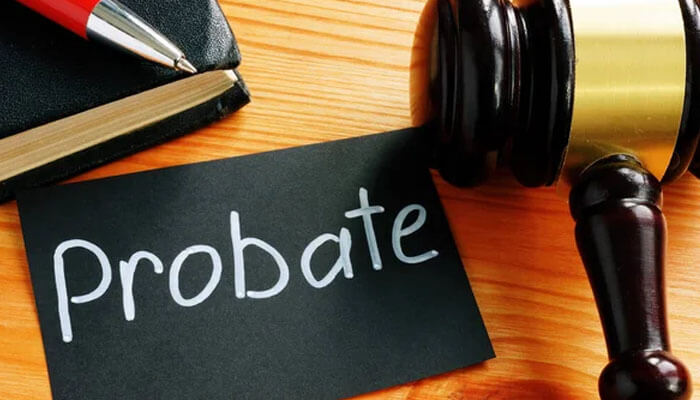 A gavel and notepad beside a card labeled Probate, symbolizing the probate process and estate settlement in court.
