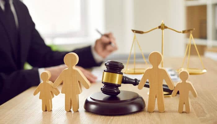 Family Lawyers - Myleagalopinion - My Legal Opinion Wooden family figures with gavel and justice scales on a lawyer’s desk — representing the best lawyer in Florida providing expert family law and legal services.