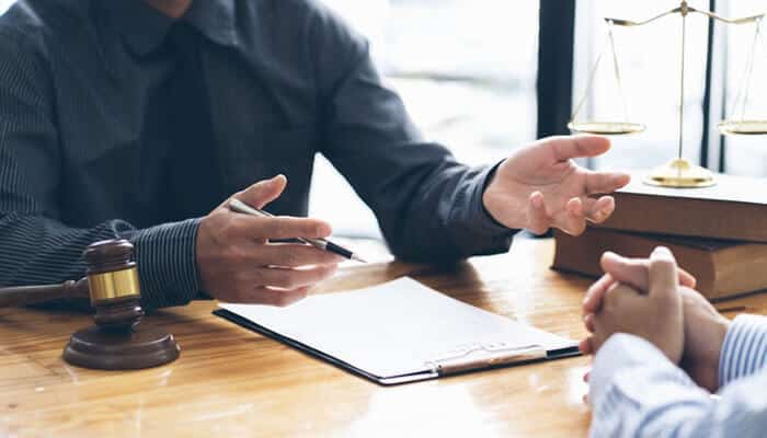 Attorney explaining legal strategies to a client on how to reduce an Unpaid Ticket Penalty and avoid further legal consequences.