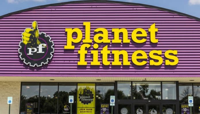 Front entrance of a Planet Fitness gym with the signature purple and yellow branding, representing the company at the center of the Planet Fitness lawsuit involving membership disputes and class action claims.
