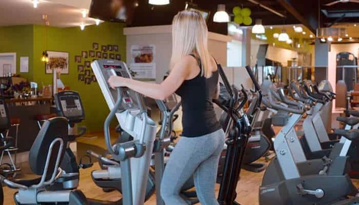 A woman using cardio equipment inside a Planet Fitness gym, highlighting the atmosphere of the fitness chain that has been at the center of the Planet Fitness lawsuit involving membership disputes and class action claims.