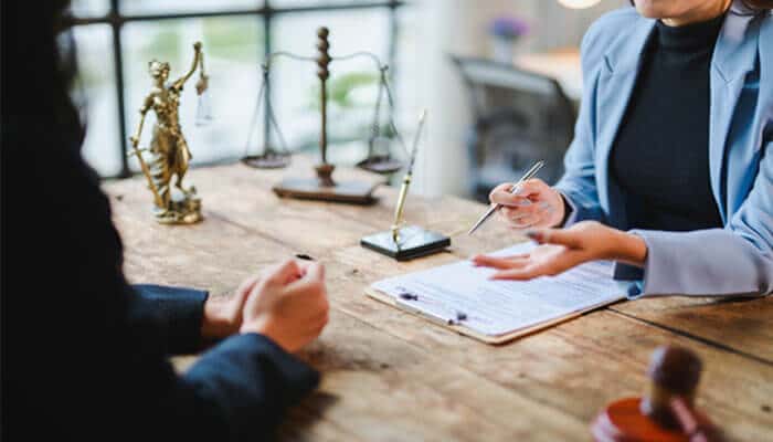 Client discussing legal documents during a consultation with a lawyer, highlighting professional legal advice and guidance in an office setting.
