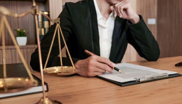 Professional attorney reviewing legal documents during a consultation with a lawyer, symbolizing legal guidance and client preparation.