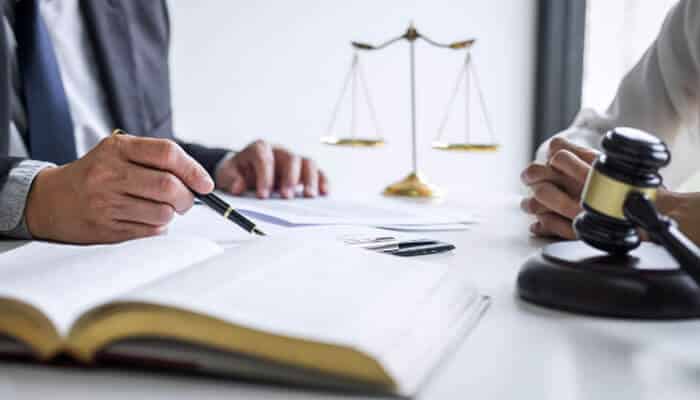 Legal consultation with documents, gavel, and scales of justice representing the Direct Fairways Lawsuit.