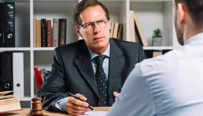 Lawyer discussing legal options with a client to reduce an Unpaid Ticket Penalty and avoid additional fines or license suspension.