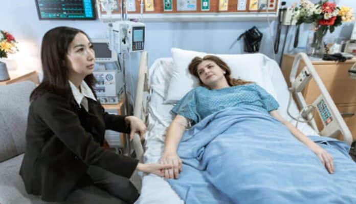 njured woman lying in a hospital bed consulting with a lawyer about filing a personal injury claim for medical expenses and compensation.