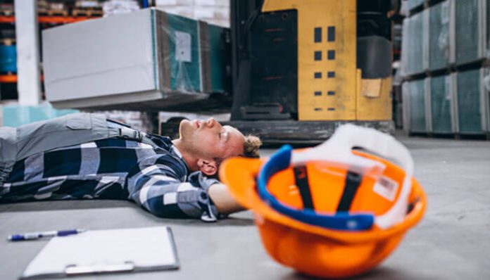 A worker injured on a construction site lying on the floor, highlighting the need for a Construction Accident Lawyer in Lafayette to claim compensation.