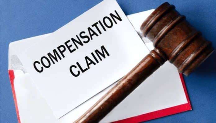 A judge’s gavel resting beside a document labeled “Compensation Claim,” representing the legal process to claim compensation for surgical error in Chicago.