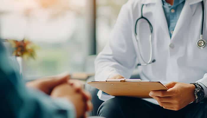 The Hidden Cost of Delayed Diagnosis - My legal opinion - My Legal Opinion A doctor consulting with a patient while holding a medical report, highlighting health concerns related to Asbestos Exposure Cases.