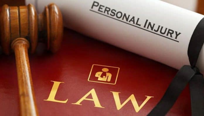 Gavel and legal book with a rolled document labeled “Personal Injury” — symbolizing how compensation is calculated in personal injury cases.