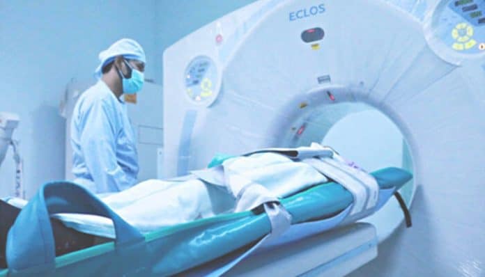A patient undergoing a medical scan with a healthcare professional nearby, emphasizing diagnostic procedures in Asbestos Exposure Cases.