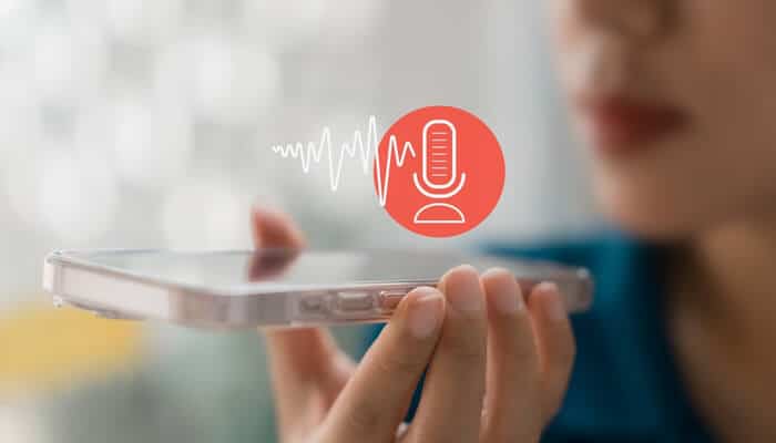 Advantages Tailored to Races - Myleagalopinion - My Legal Opinion A person speaking into a smartphone using a voice recording feature, representing confidential reporting through Whistleblower Hotline Services.