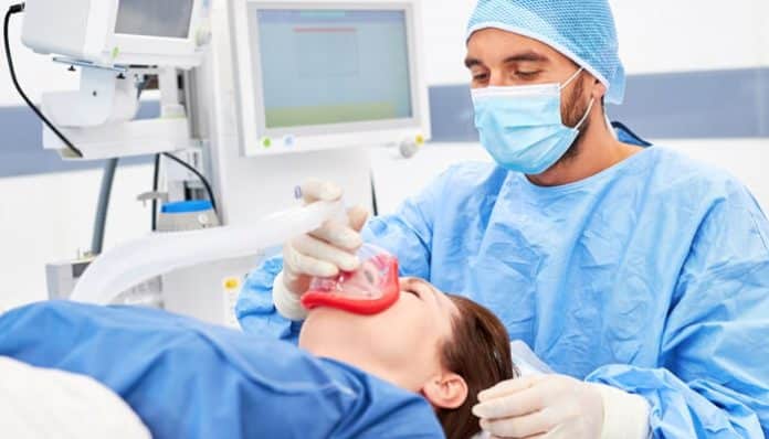 A medical professional administering anesthesia to a patient with a mask, emphasizing the importance of careful anesthesia administration to avoid errors.