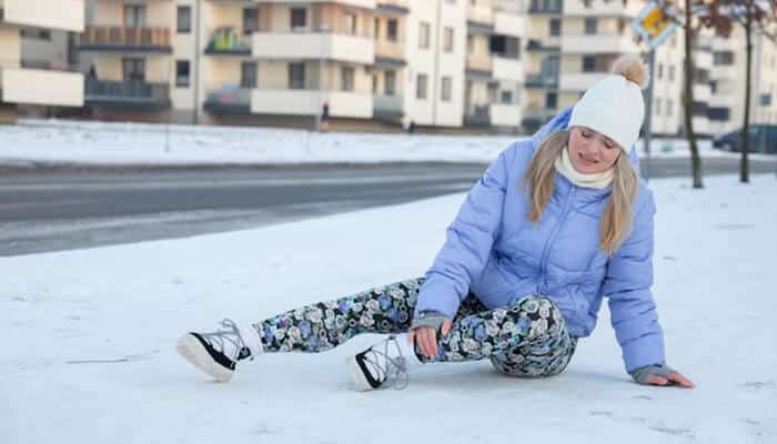 Winter slip and fall accident on icy sidewalk, illustrating how invisible ice causes serious injuries without warning.
