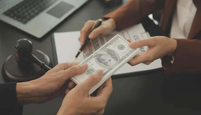 Compensation discussion related to medical negligence, showing legal documents and financial settlement for patient harm.