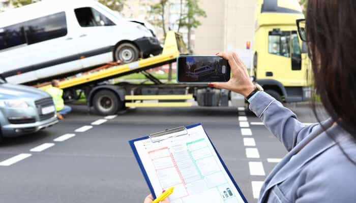 Document and Preserve the Accident - Myleagalopinion - My Legal Opinion Person documenting a truck accident scene, capturing important details for insurance claims and legal proceedings.