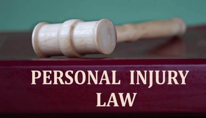 Personal injury lawsuit concept showing a judge’s gavel and legal text representing injury claims and negligence law