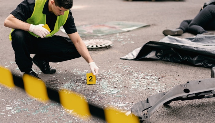 Gathering Evidence and Building Your Case - Myleagalopinnion - My Legal Opinion Truck Accident Lawyer investigating a crash scene with evidence markers and vehicle debris.