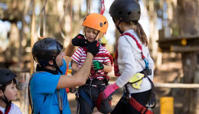 Helmet Requirements for Different Age Groups - Myleagalopinion - My Legal Opinion Children wearing helmets and safety gear, highlighting the importance of helmet laws and safety regulations in bicycle laws for safe cycling practices.