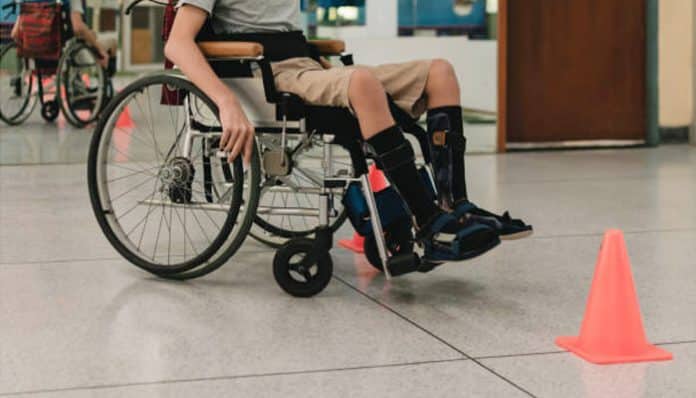 Permanent injuries victim using a wheelchair during rehabilitation after a serious accident, highlighting long-term mobility challenges