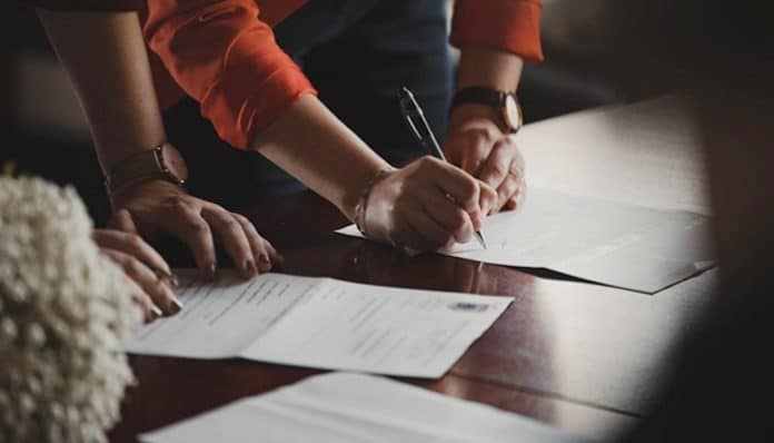 People signing documents related to legal deadlines in injury claims, ensuring timely actions to protect their rights and secure compensation.