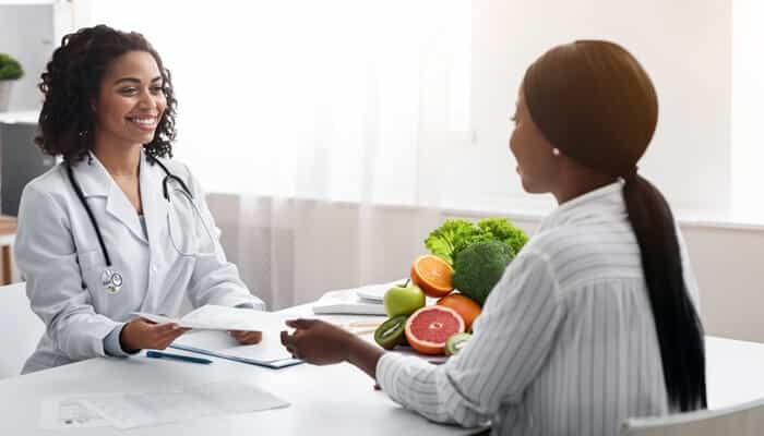 Support Through All Career Stages - Myleagalopinion - My Legal Opinion Michael Johnson Legal: A physician discussing a contract with a patient, representing the importance of legal support for healthcare professionals in contract negotiations.