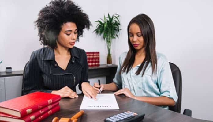 Female attorney explaining Mesothelioma legal rights to a client during a legal consultation.