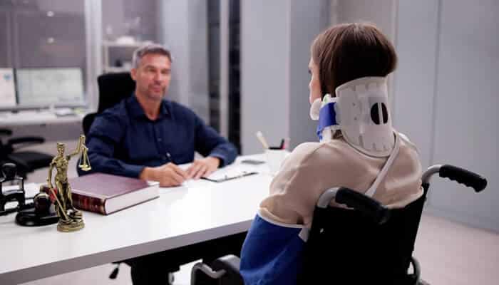 They Know the Real Value of Your Claim - Myleagalopinion - My Legal Opinion Injured person in wheelchair consulting a lawyer for a Personal Injury Claim