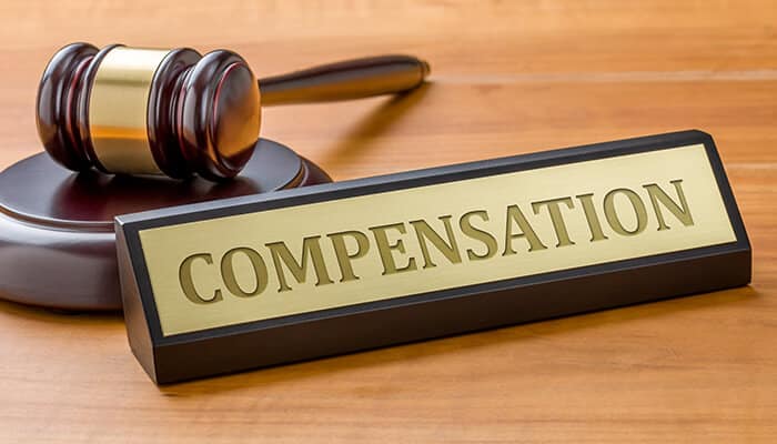 Road Accident in Arkansas compensation concept with judge’s gavel and legal sign representing injury claims and financial recovery.