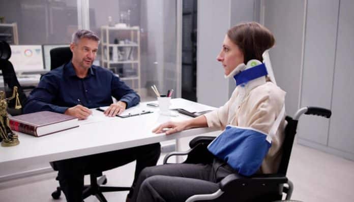 Injured person consulting with a lawyer during a personal injury claim discussion following an accident.